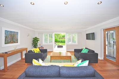 brown-wooden-coffee-table-near-black-sofa-near-the-window-210552