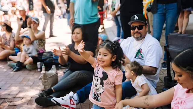 Waving child with family at the Flint Hills Family Festival. Photo by Laura Alpizar.