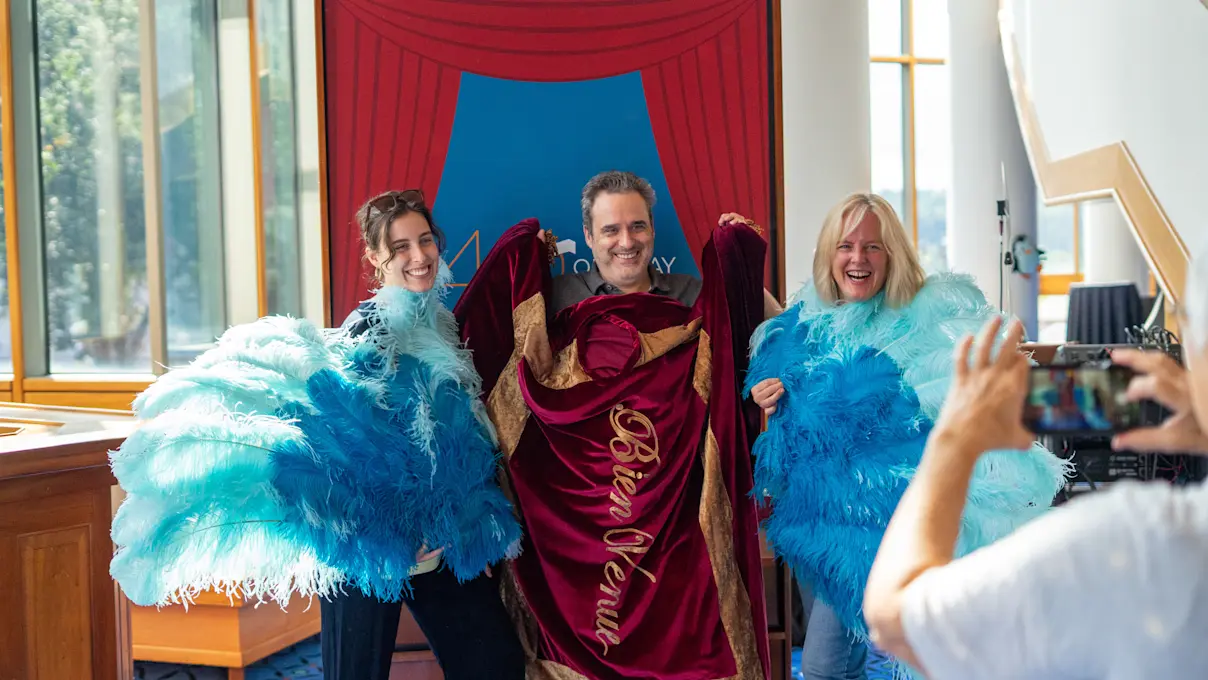 Guests trying on Broadway costumes at the 40th Anniversary Open House. Photo by Imani Mansfield.
