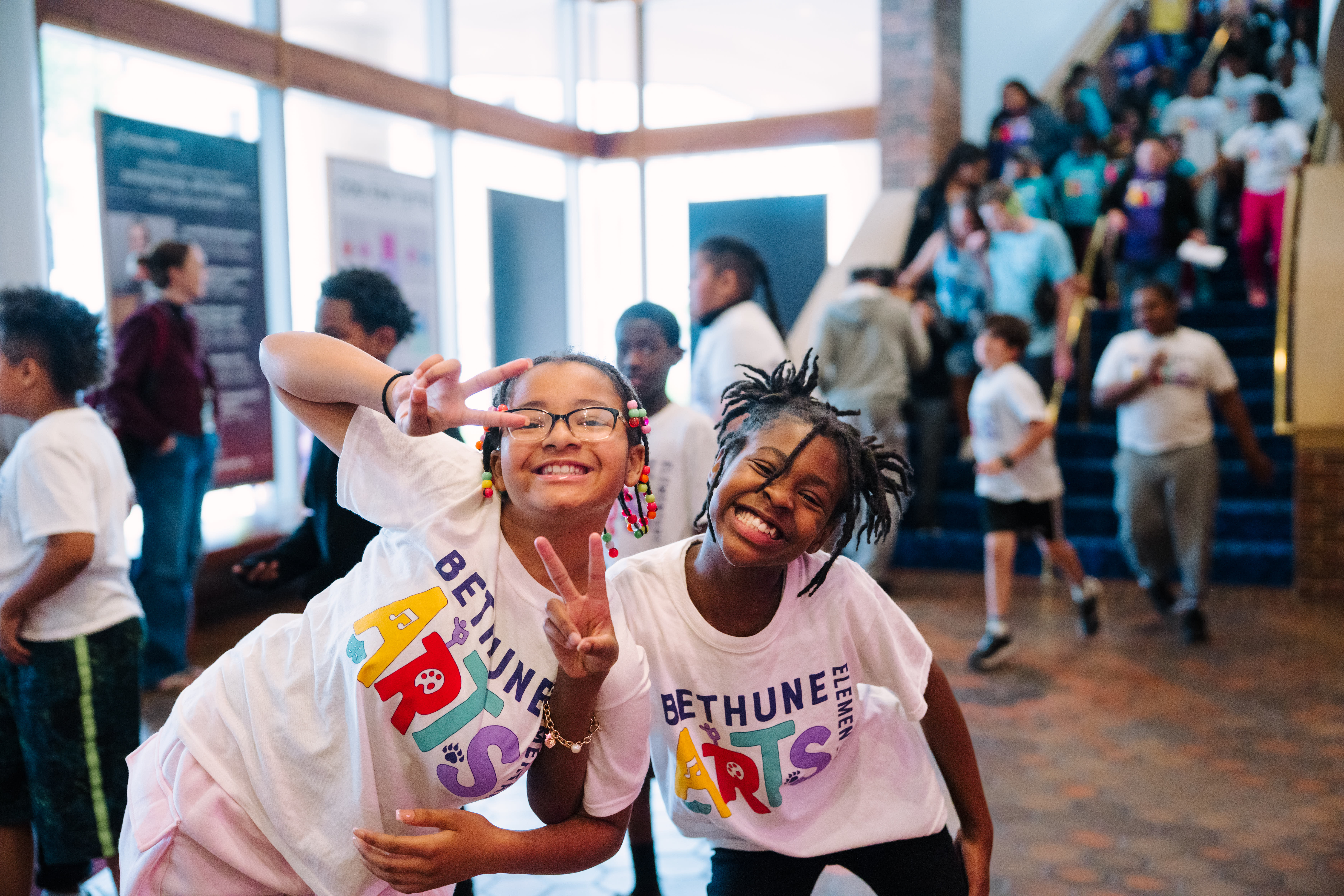 Students smiling for the camera from the Ordway lobby at the Flint Hills Family Festival 2025. Photo by Laura Alpizar.