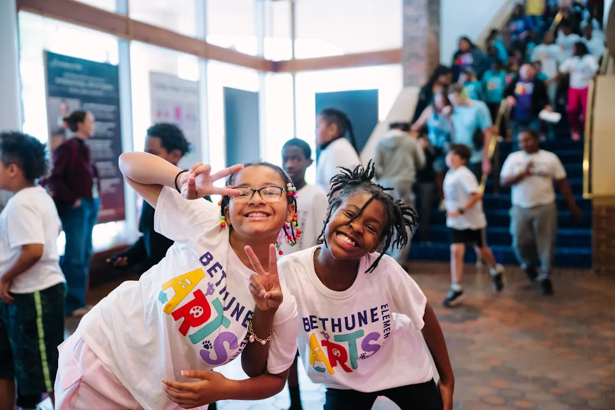 Students smiling for the camera from the Ordway lobby at the Flint Hills Family Festival 2025. Photo by Laura Alpizar.