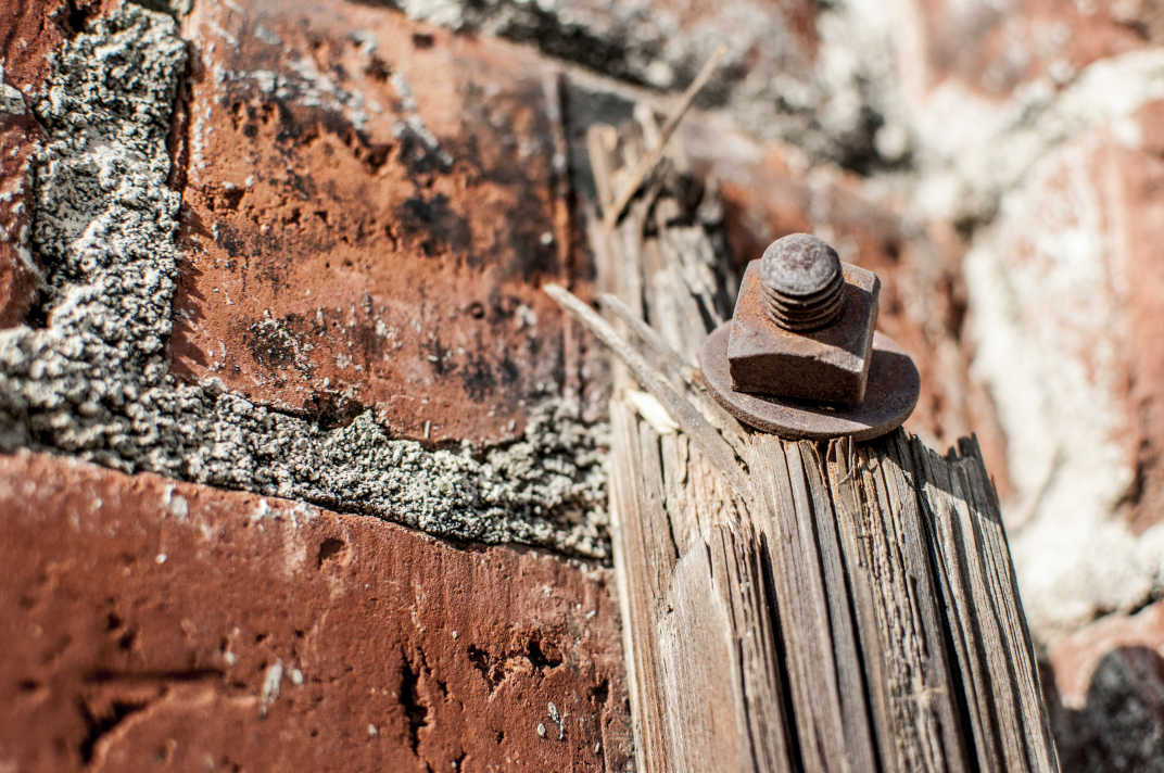 Rusted screw in a brick wall in Banning, California. 