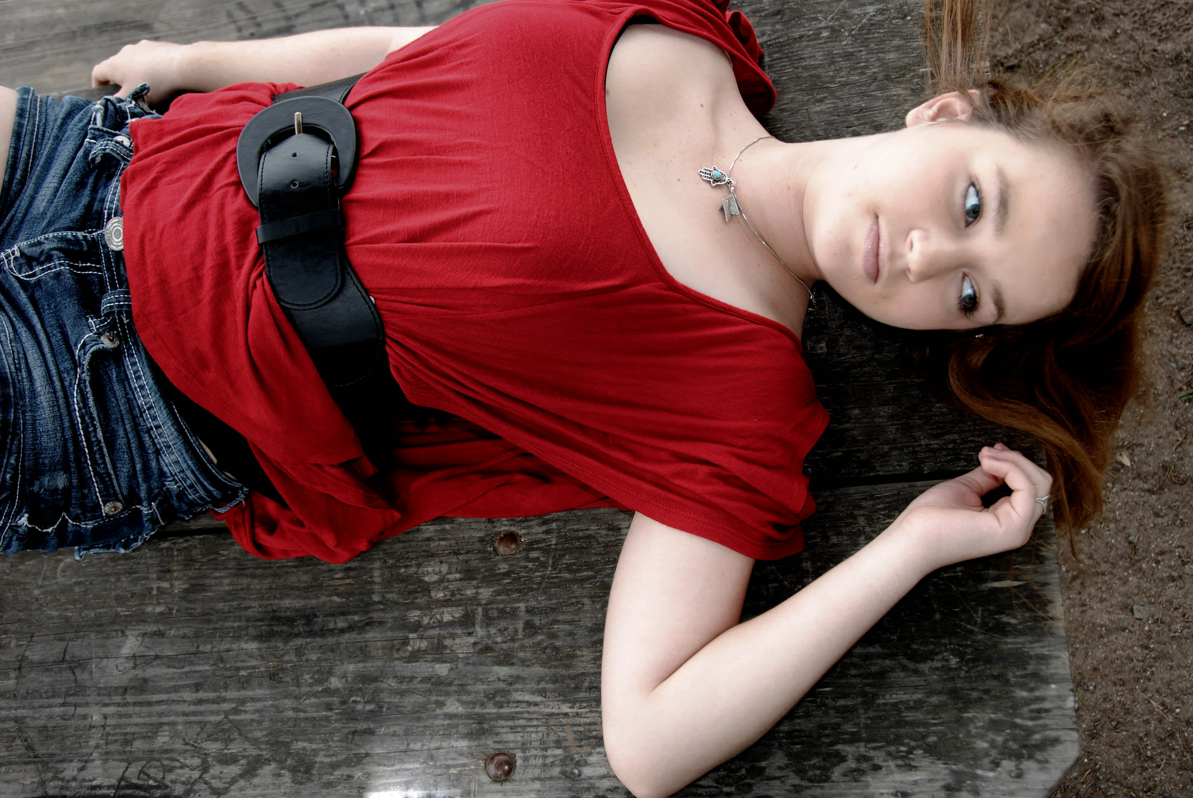 Girl in red laying on the floor. 