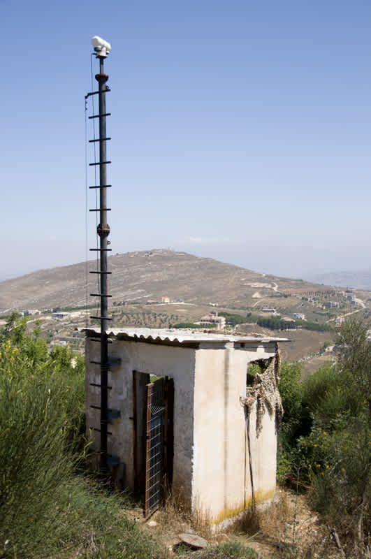 Security Camera on top of a pole by a simple guard station in Kibbutz Misgav Am, Golan Heights, Israel. 