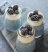a group of blue and white cupcakes with blueberries in them