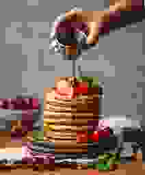 a person lighting a candle on a cake