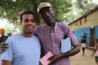 Suleiman Shifaw with father of the three children