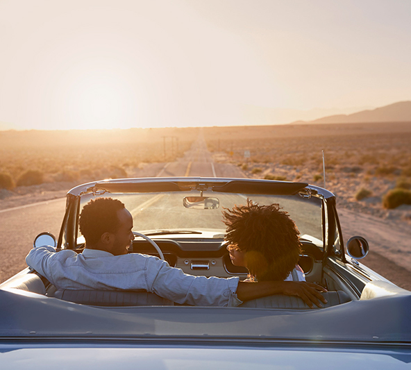 couple-driving-convertible-sunset-los-angeles-592x533