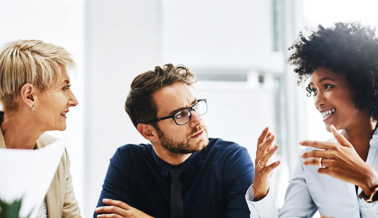 three people having a meeting together