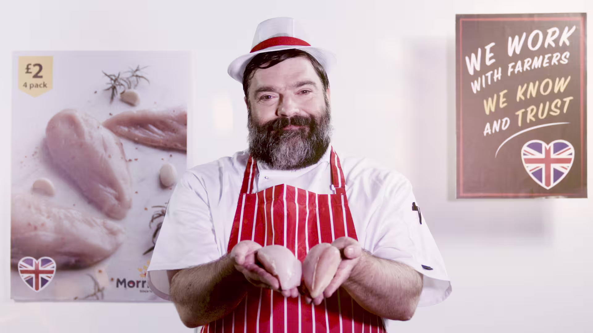 Morrisons poster of a butcher holding two chicken breasts