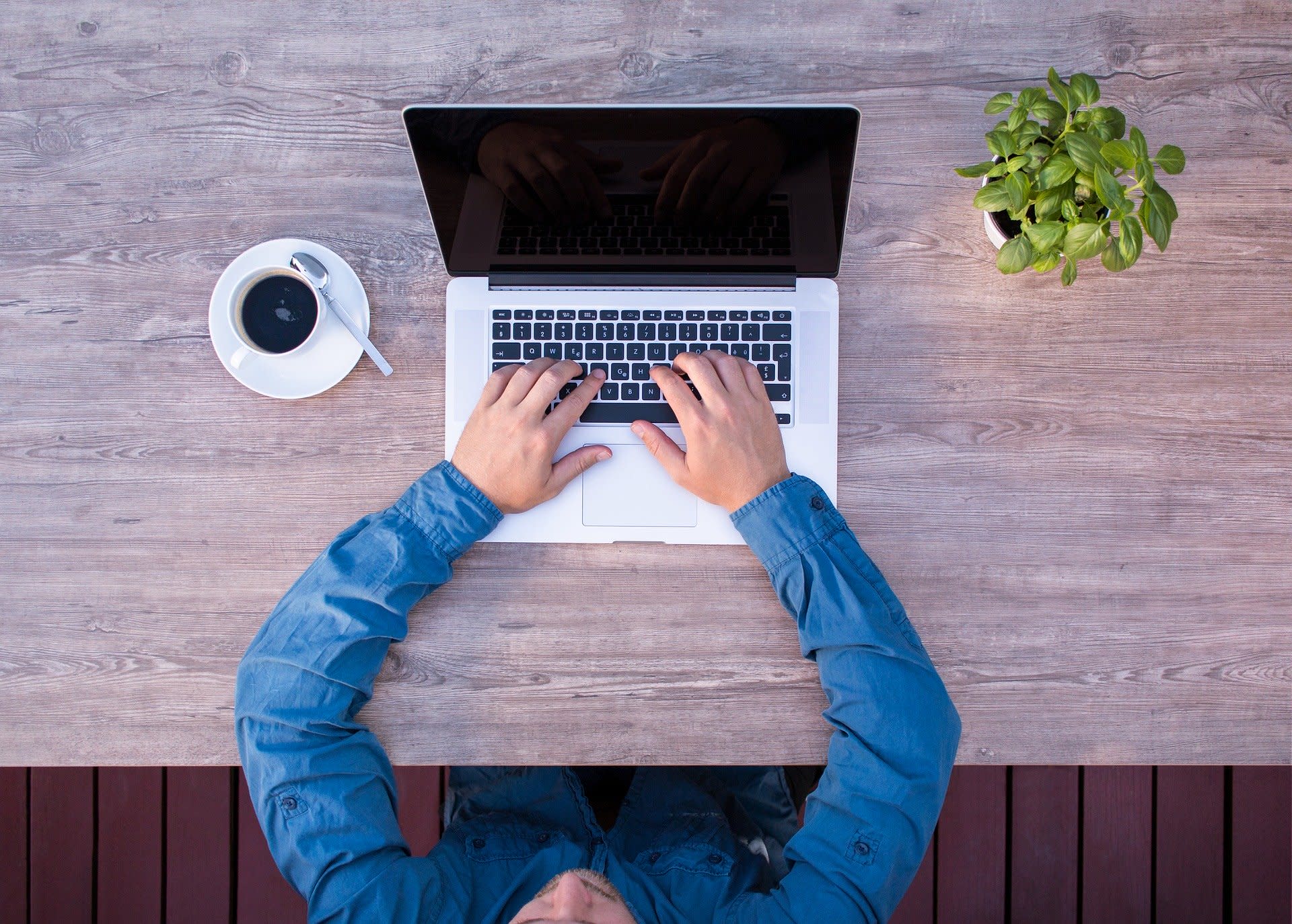 Man at laptop working with coffee