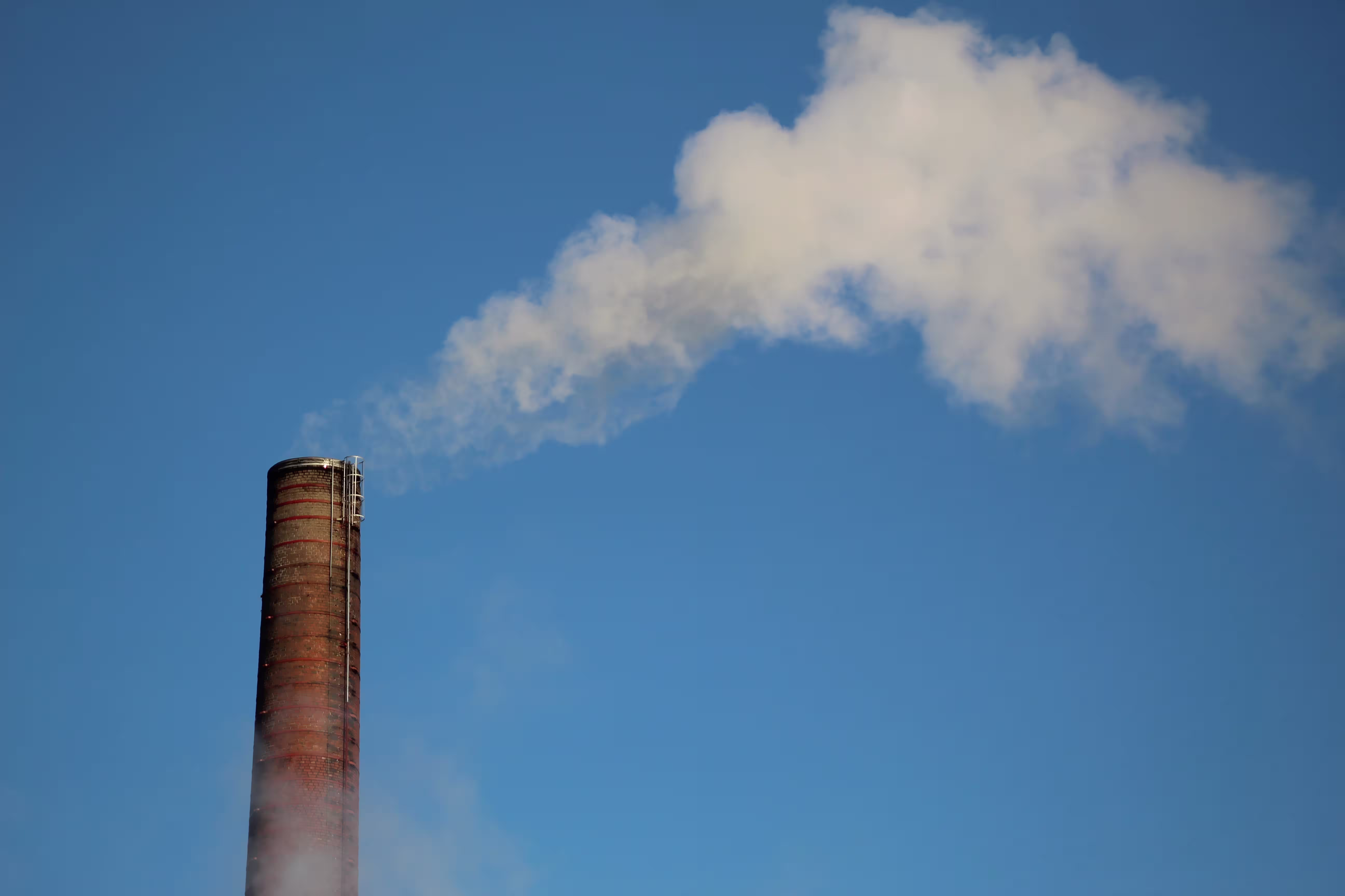 Smokestack emitting gas into the sky