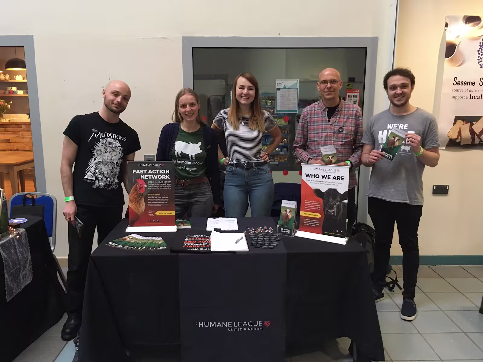 Five volunteers standing in front of a stall