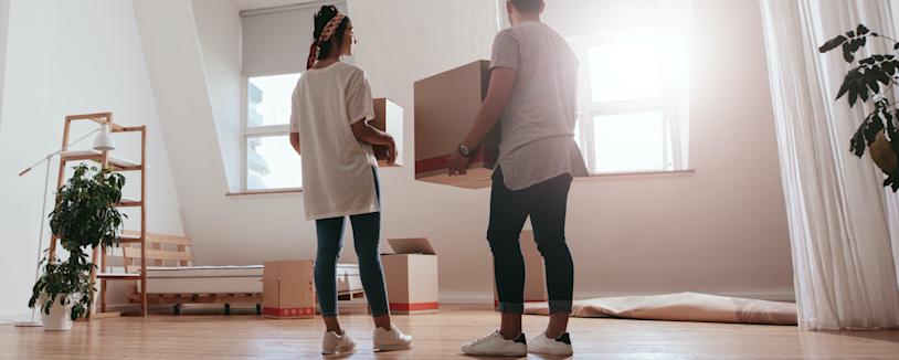 Feature image - Residential tenancy Couple moving boxes into empty room