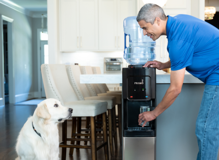 Man with a dog, drinking water