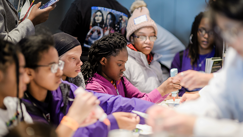 A photo of a group of youngsters working on a group activity.