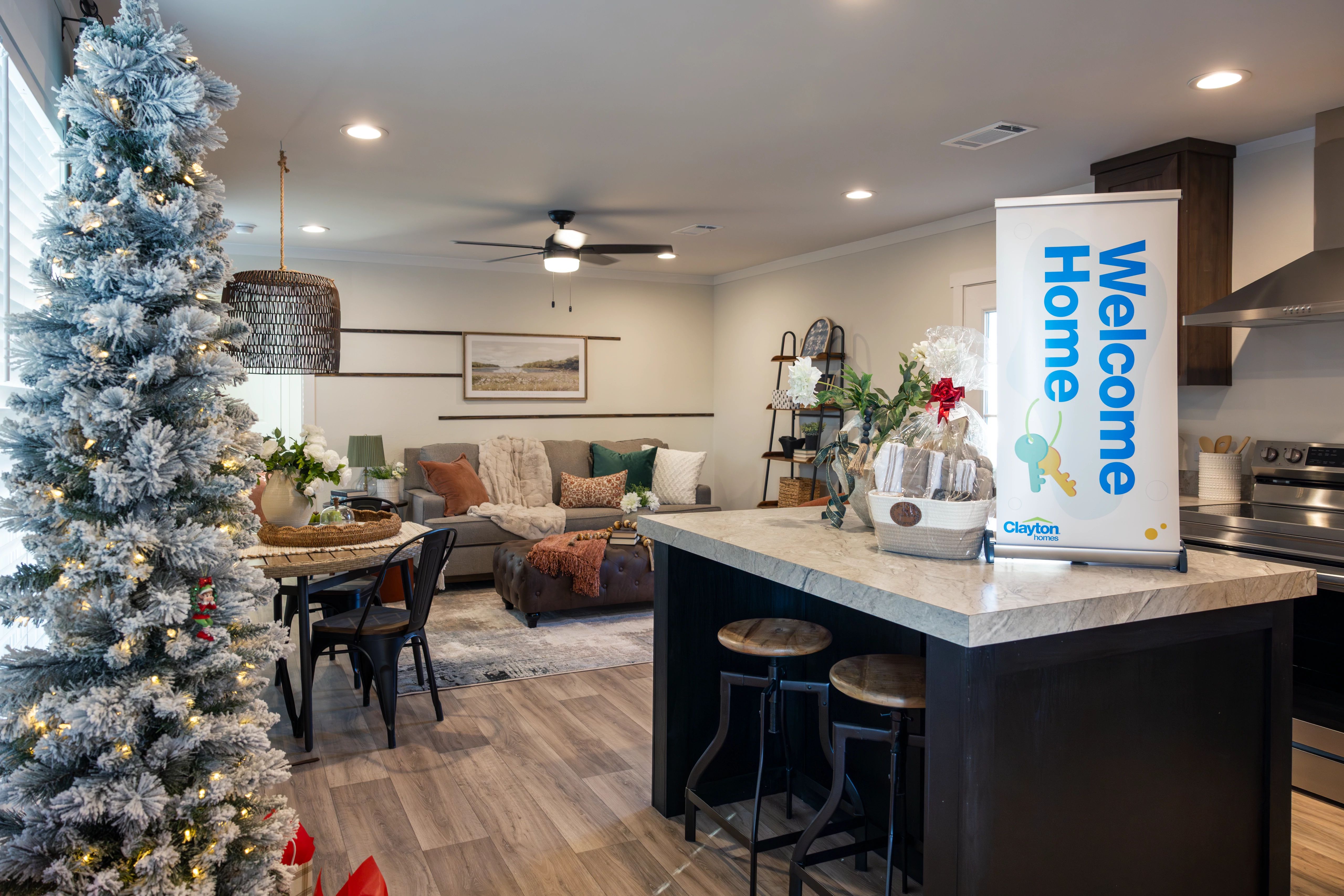 Interior of a manufactured home with the kitchen and island on the right and living room in the background