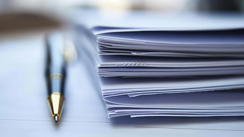 Report documents on table with a pen