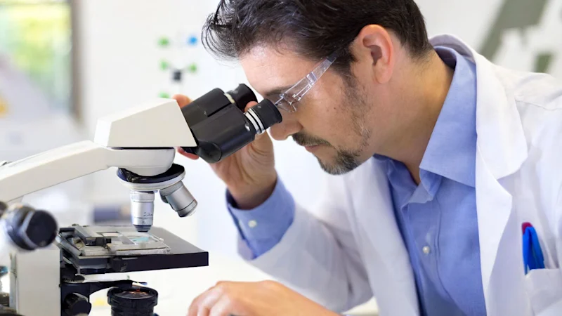 Person using a microscope in a lab