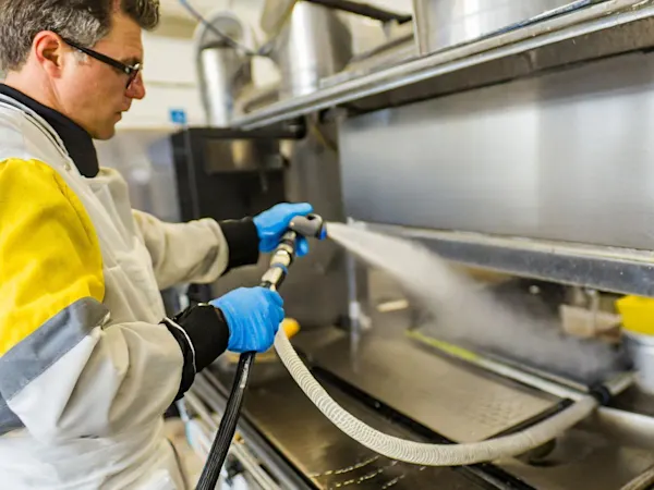 Person disinfecting a work area