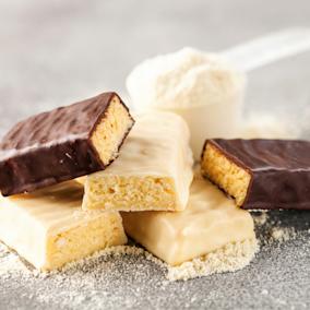 Three protein bars, broken into halves.