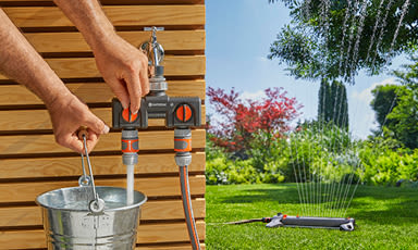 Hender kobler oransje-grå slangesplitter til hagekran over bøtte, ved grønn plen med sprinkler.