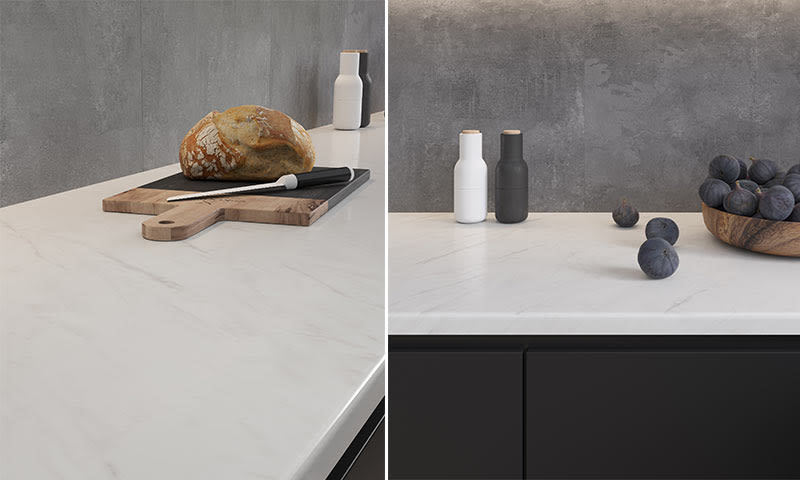 Moderne kjøkken med hvit marmorbordplate mot grå betongvegg, brød på trefjøl, fiken og kverner