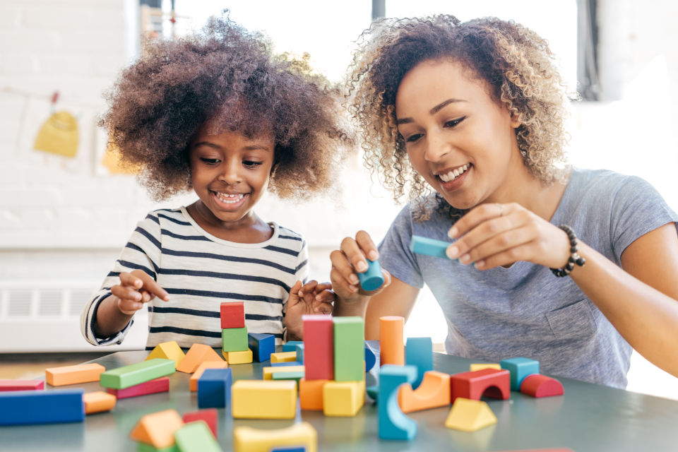 Mom Daughter building with colorful blocks