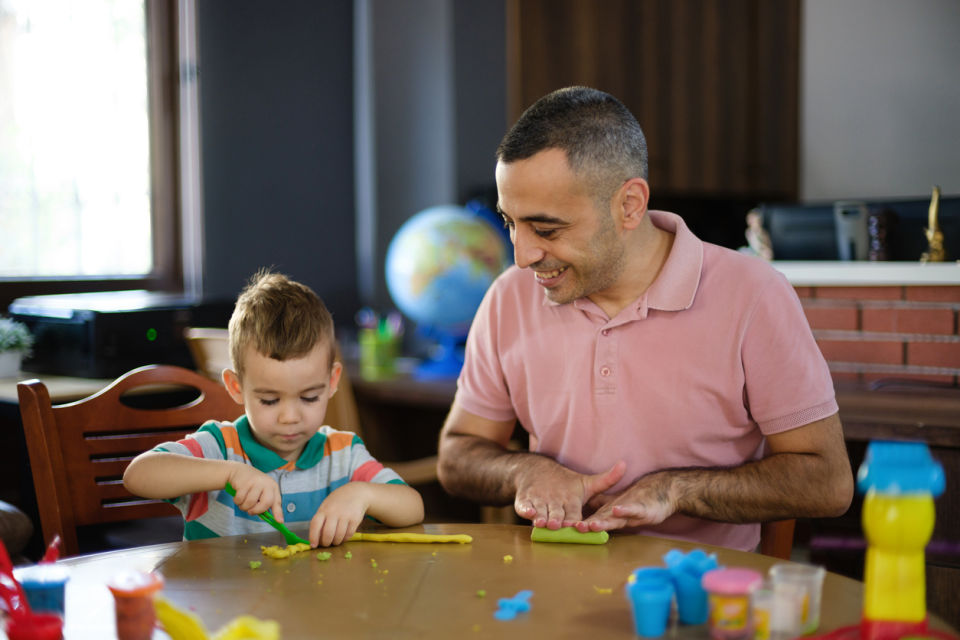 Father and child playing with playdough
