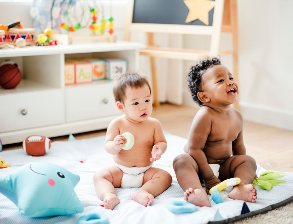 Two baby boys on blanket