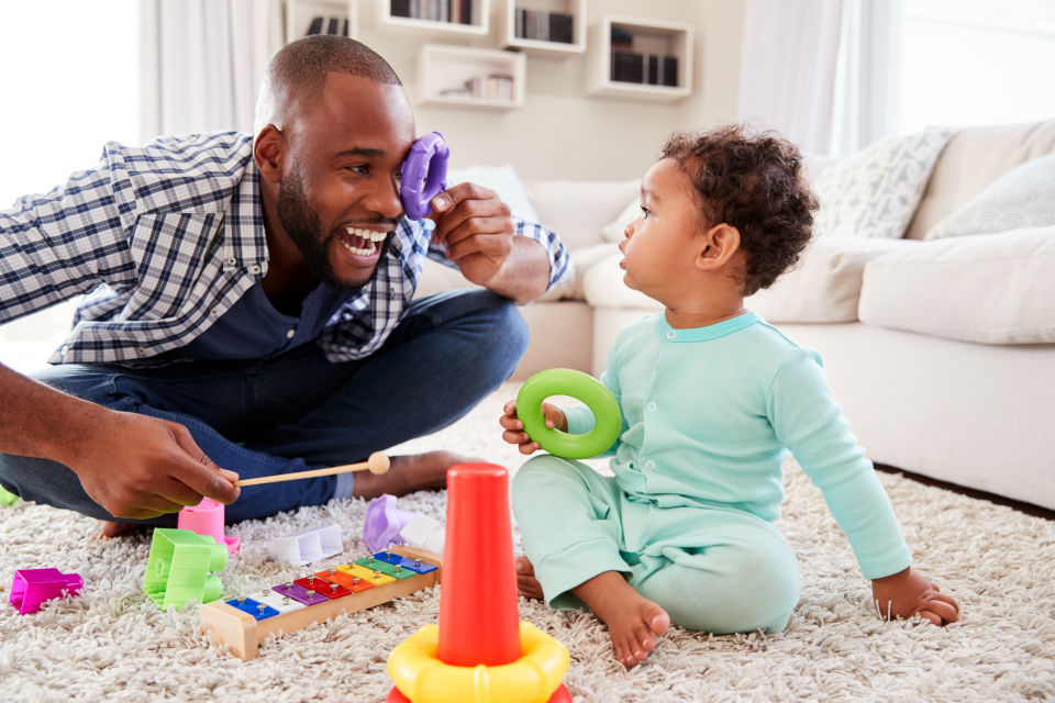 Father playing with kids toys