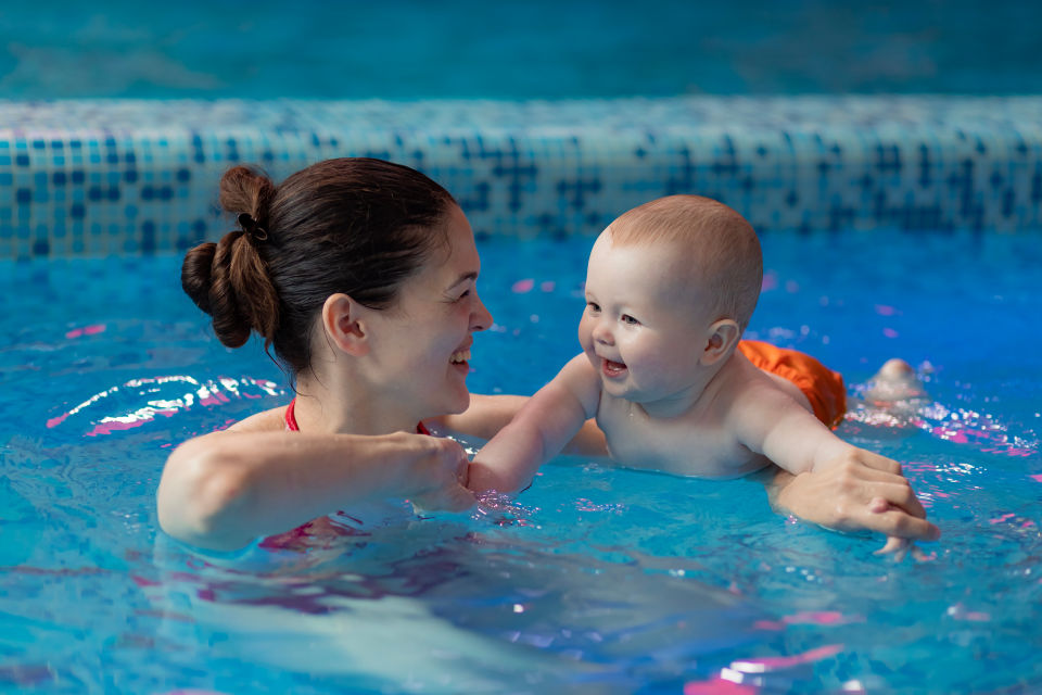 Mother and baby in pool