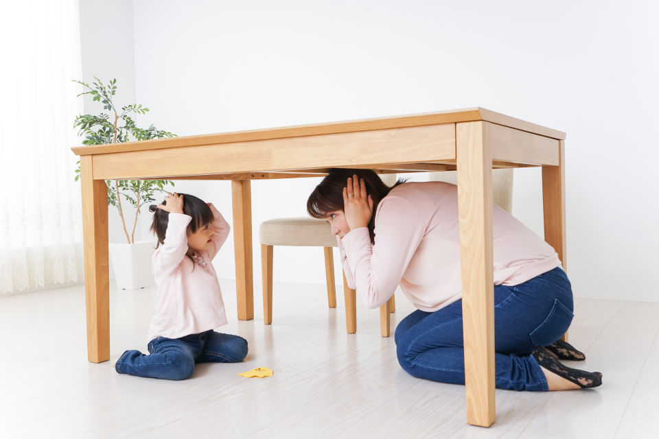 Mother and daughter practicing earthquake drills