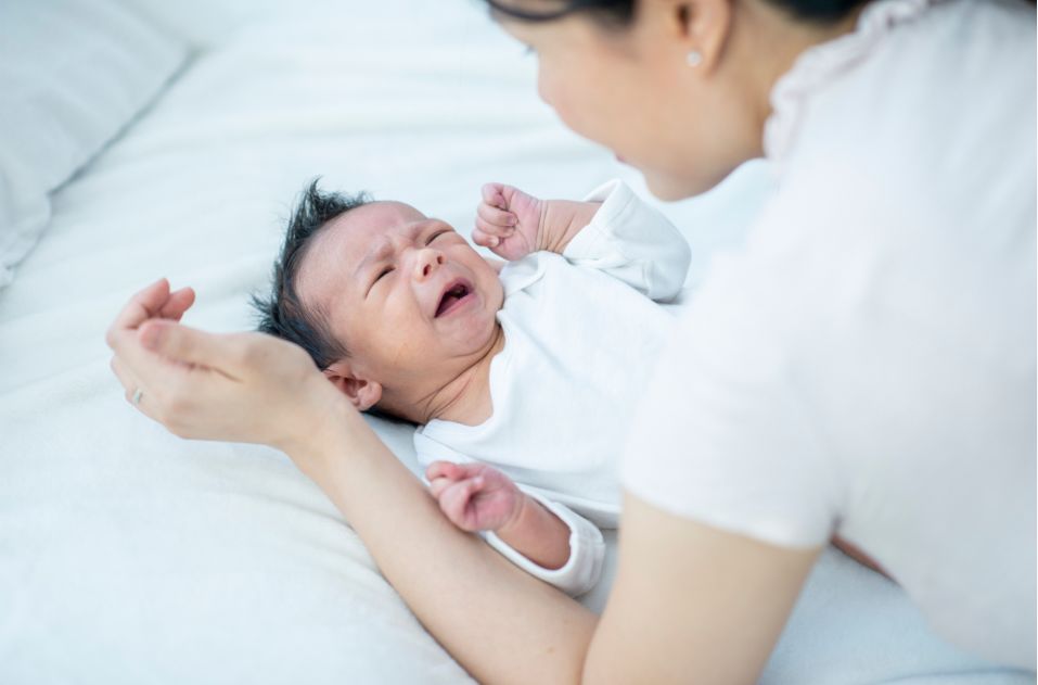 Mother comforting crying baby Mother comforting crying baby