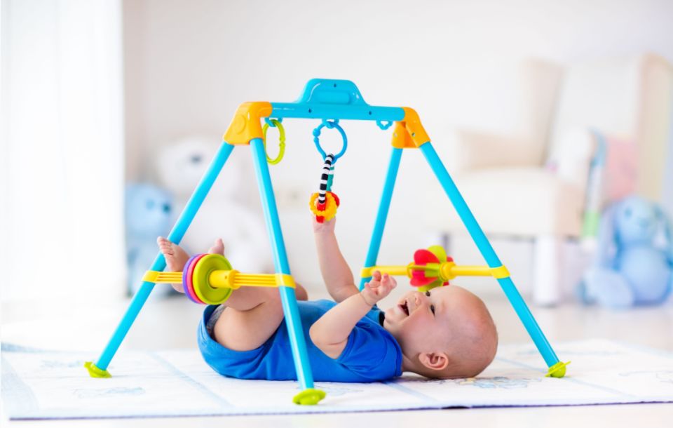 Baby playing with baby rocker toys         