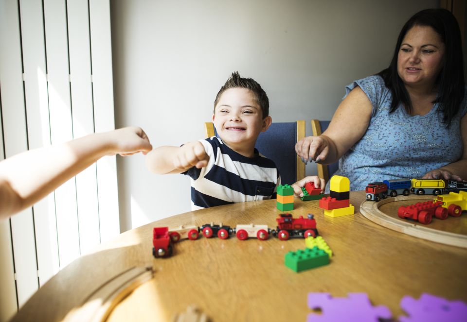 Boy with special needs doing a fist bump