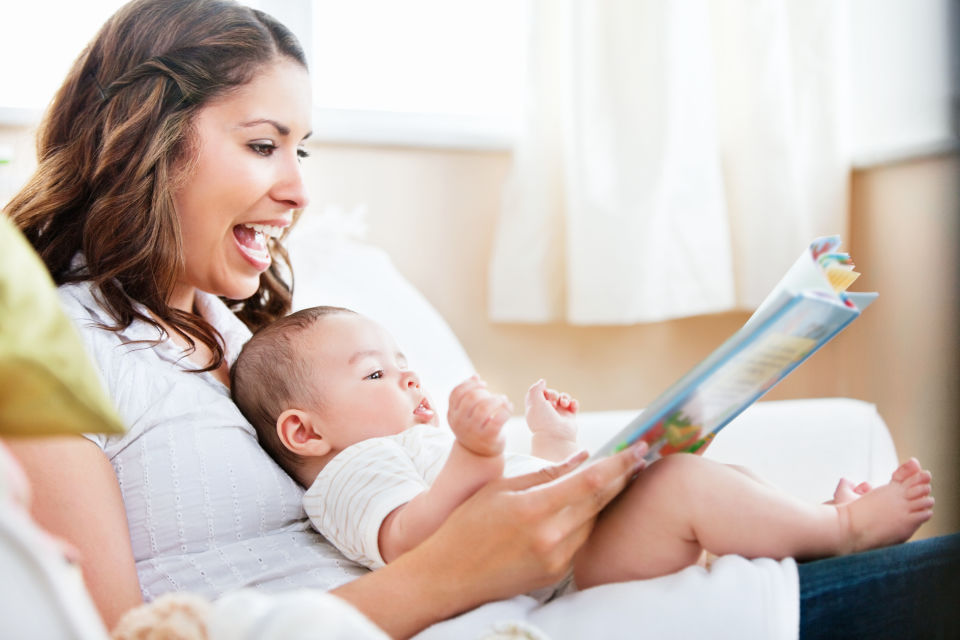 Mother on couch Reading to baby