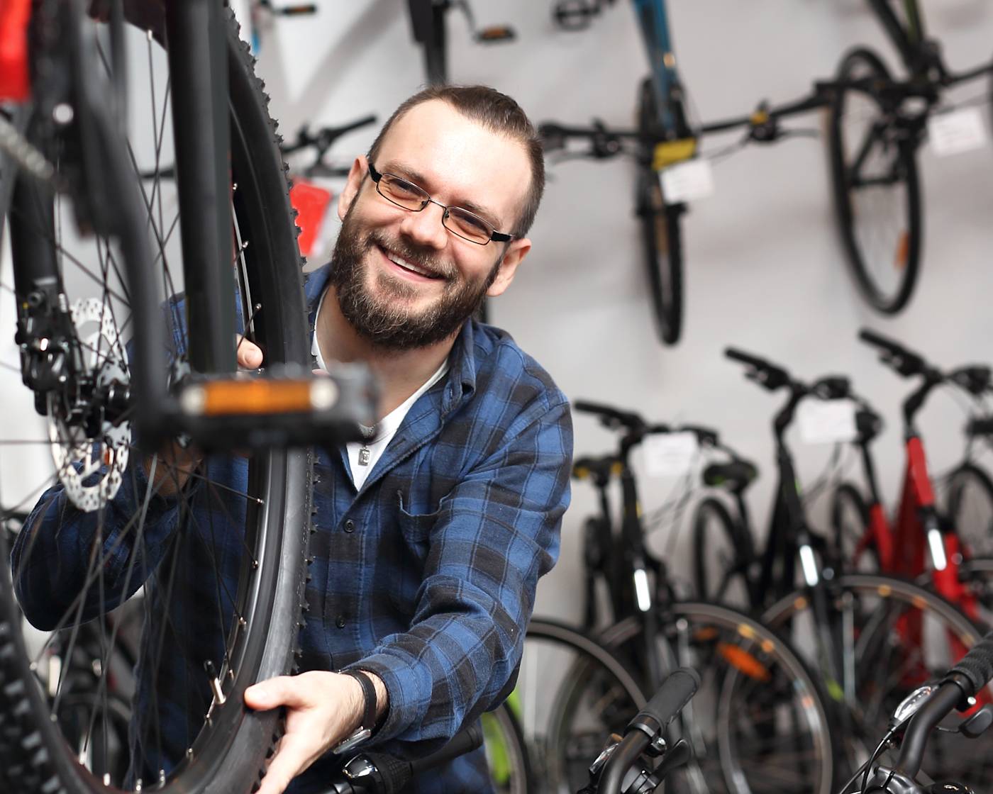 Bloke in a bike shop, surrounded by bikes