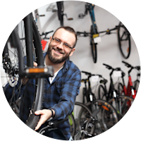 Bloke in a bike shop, surrounded by bikes