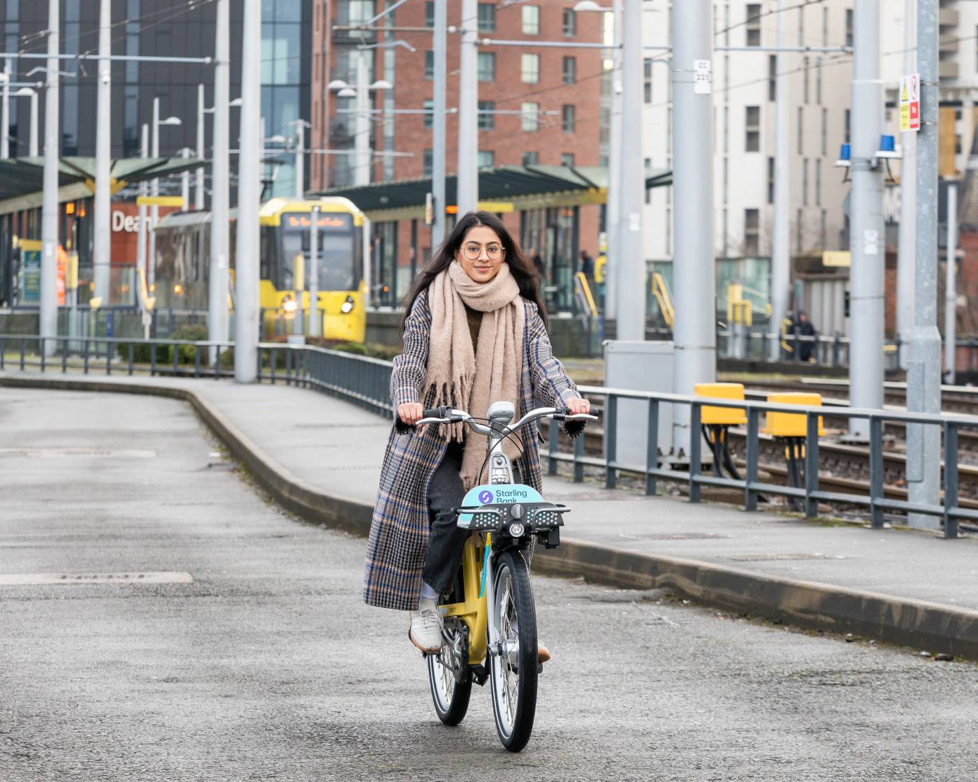 Person riding a starling bank bike in Manchester