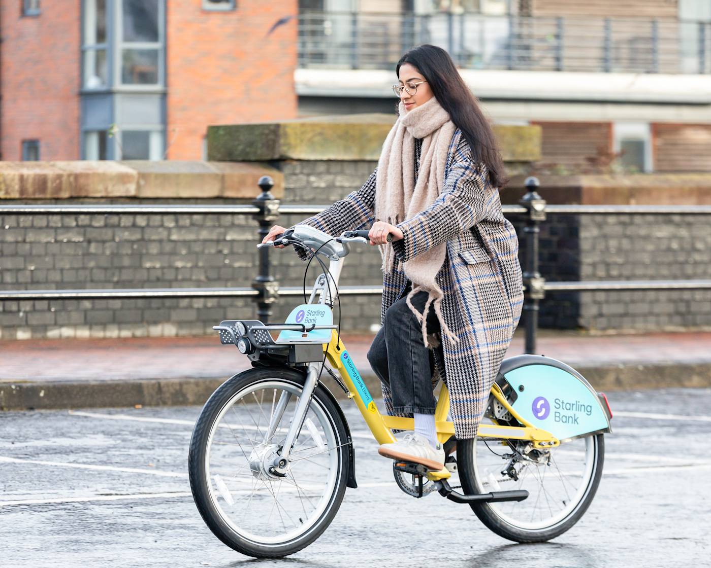 Starling bank bike hire customer riding a bike in Manchester