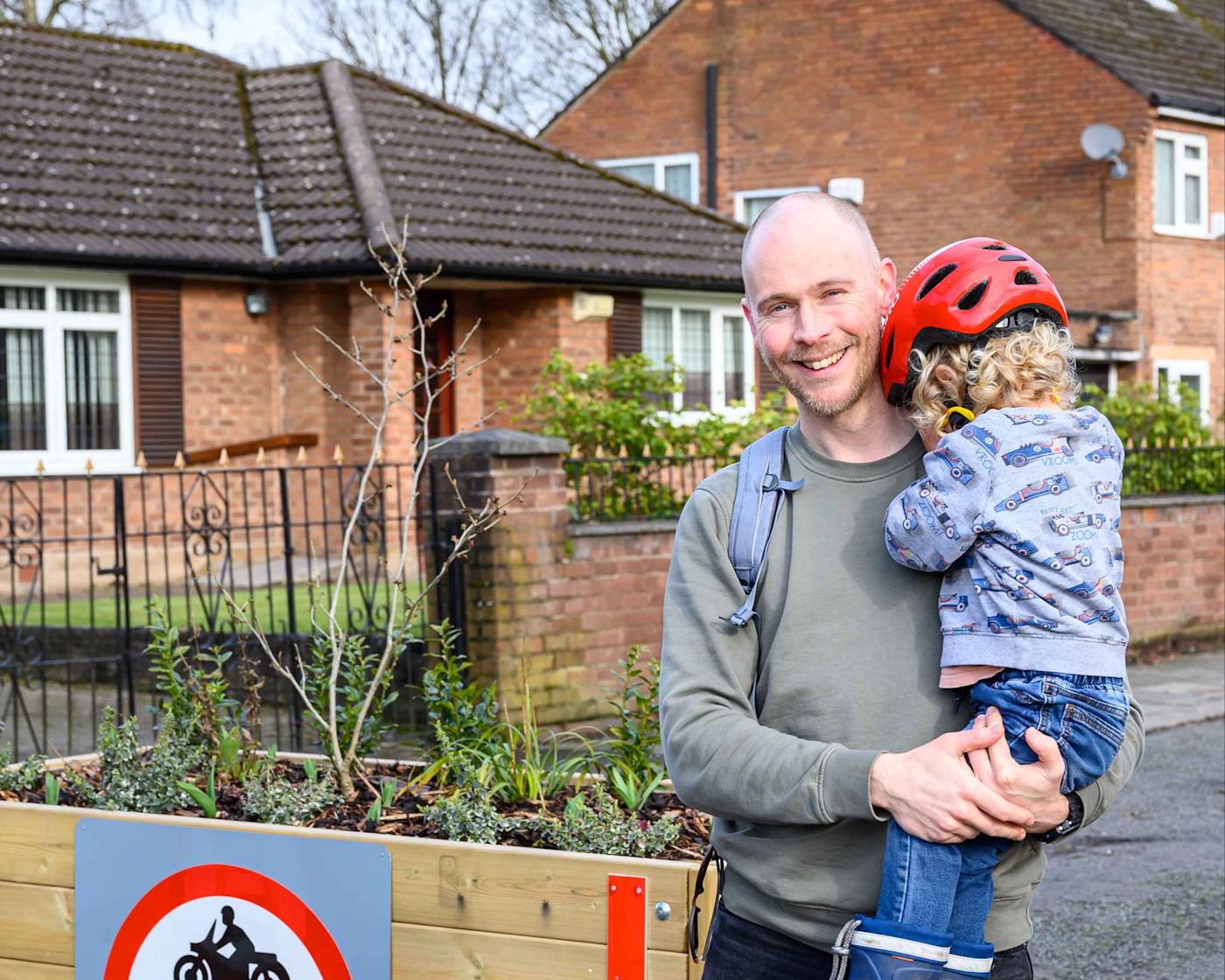 A picture of a father and a child in a low traffic neighbourhood