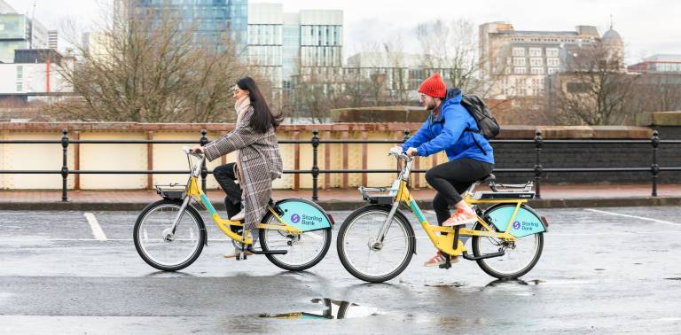 Two cyclists using starling bank bikes in Manchester