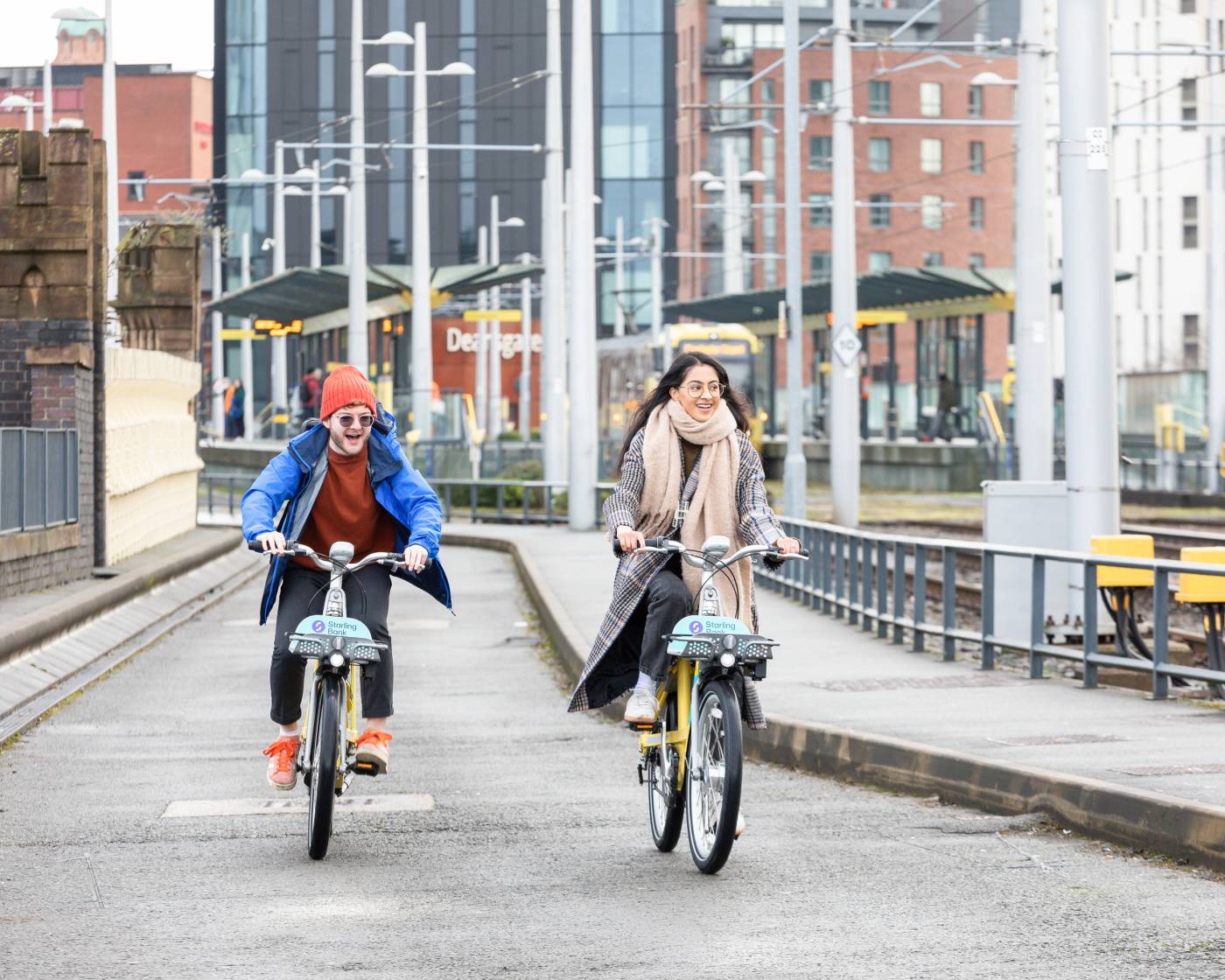 Two cyclists using starling bank bike hire in Manchester