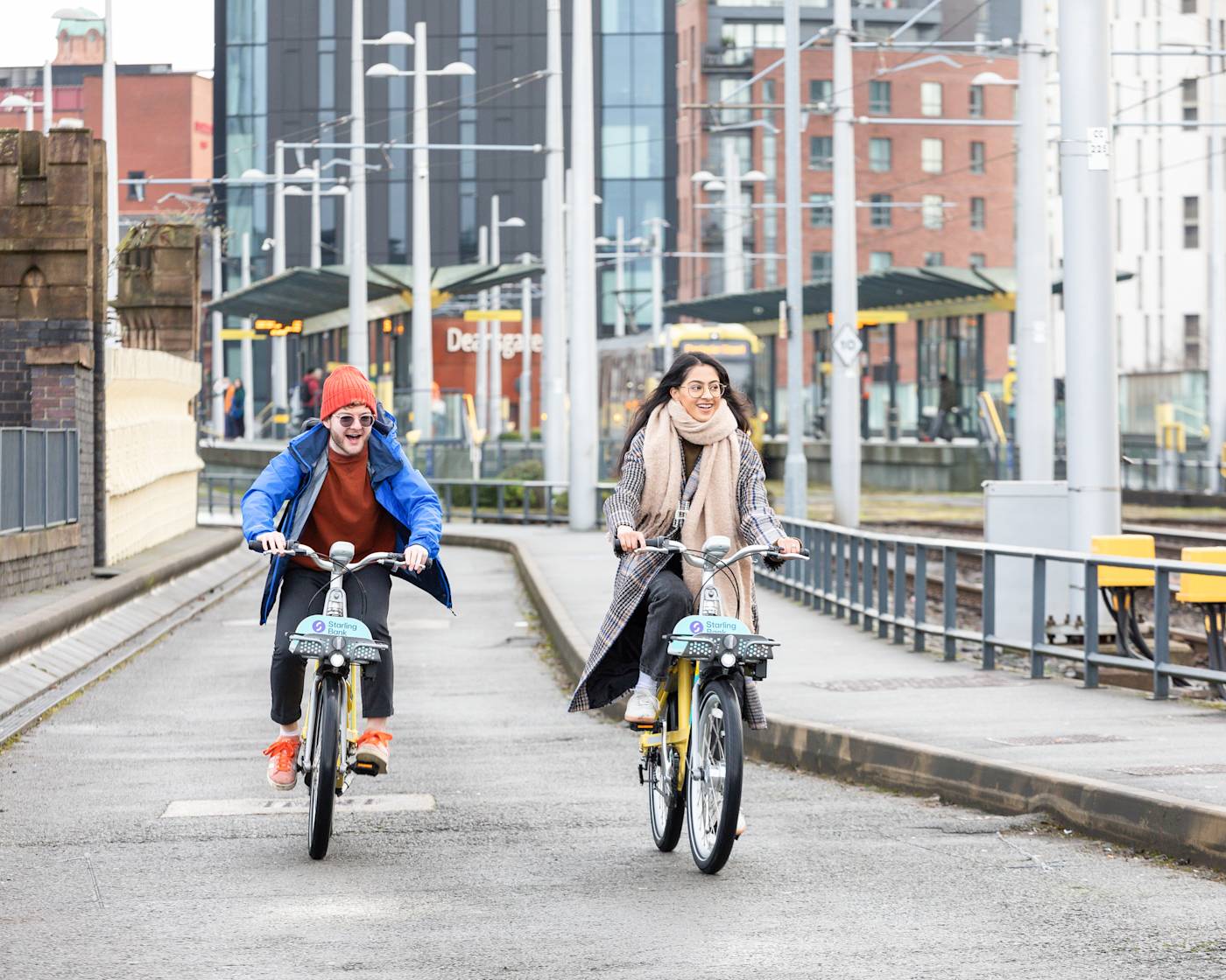 Two cyclists using starling bank bike hire in Manchester