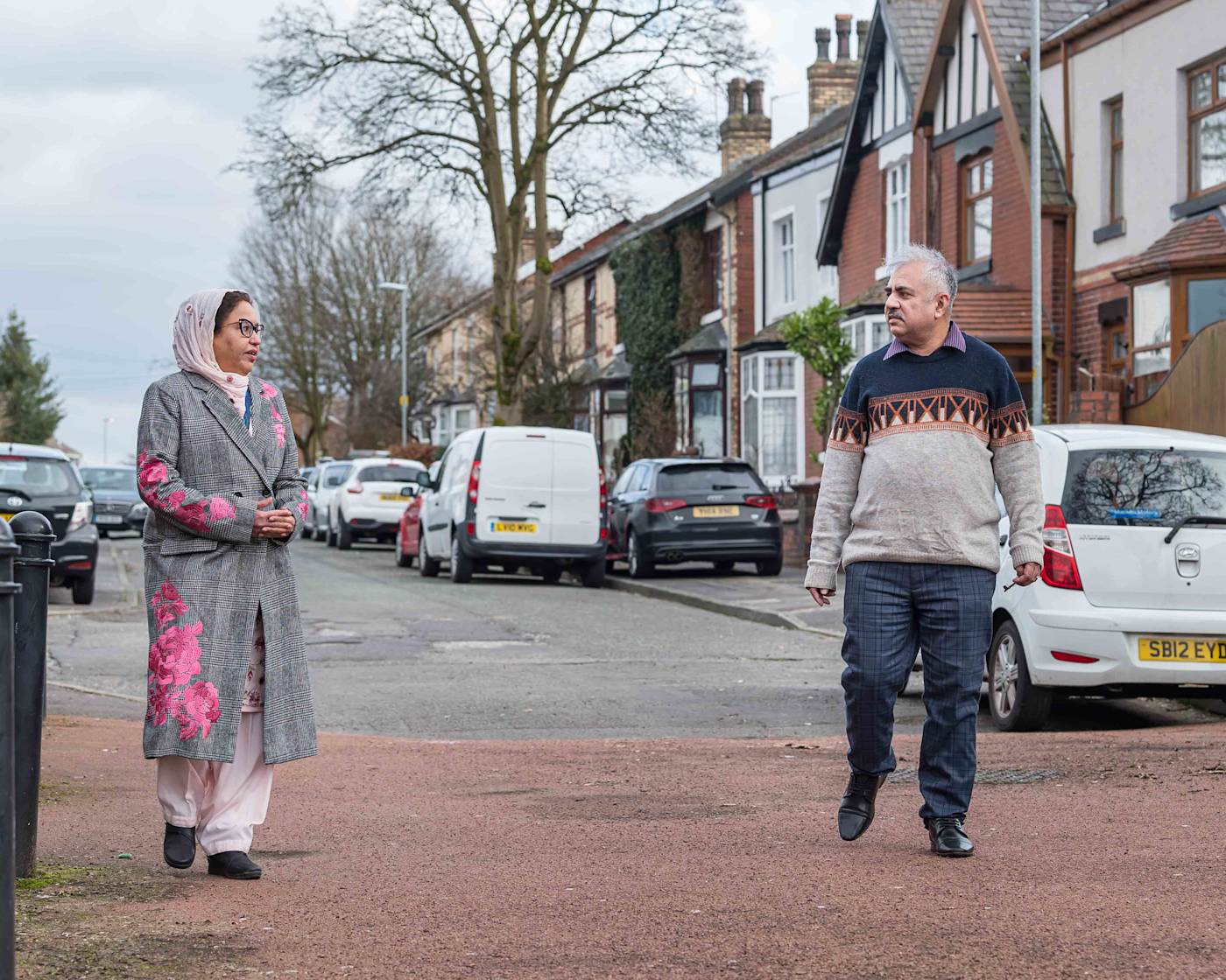Asian man and woman walking on cul de sac