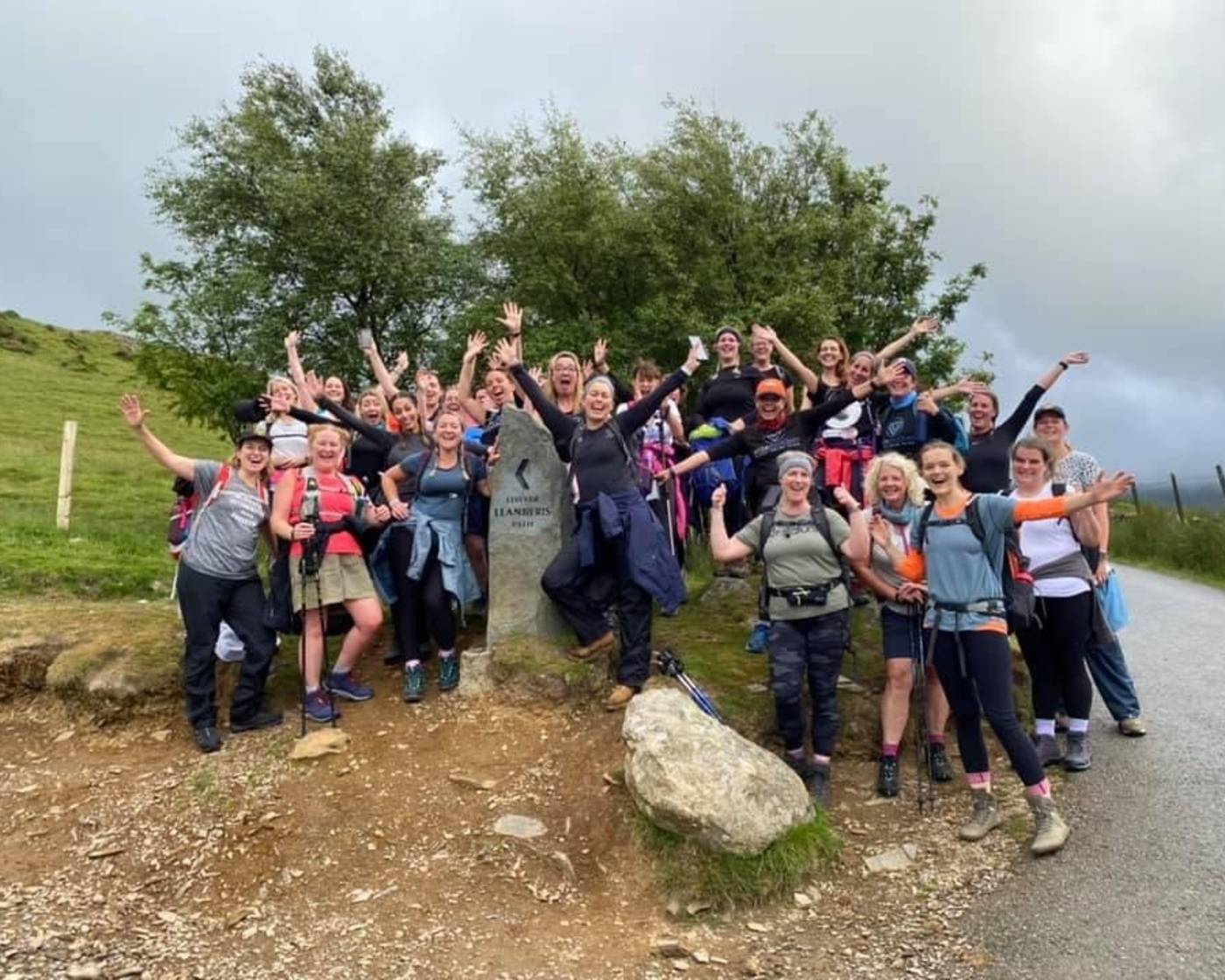Cycle and stride group solemother with their arms up on a walk