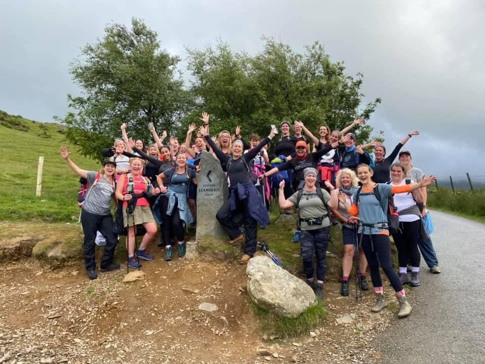 Cycle and stride group solemother with their arms up on a walk