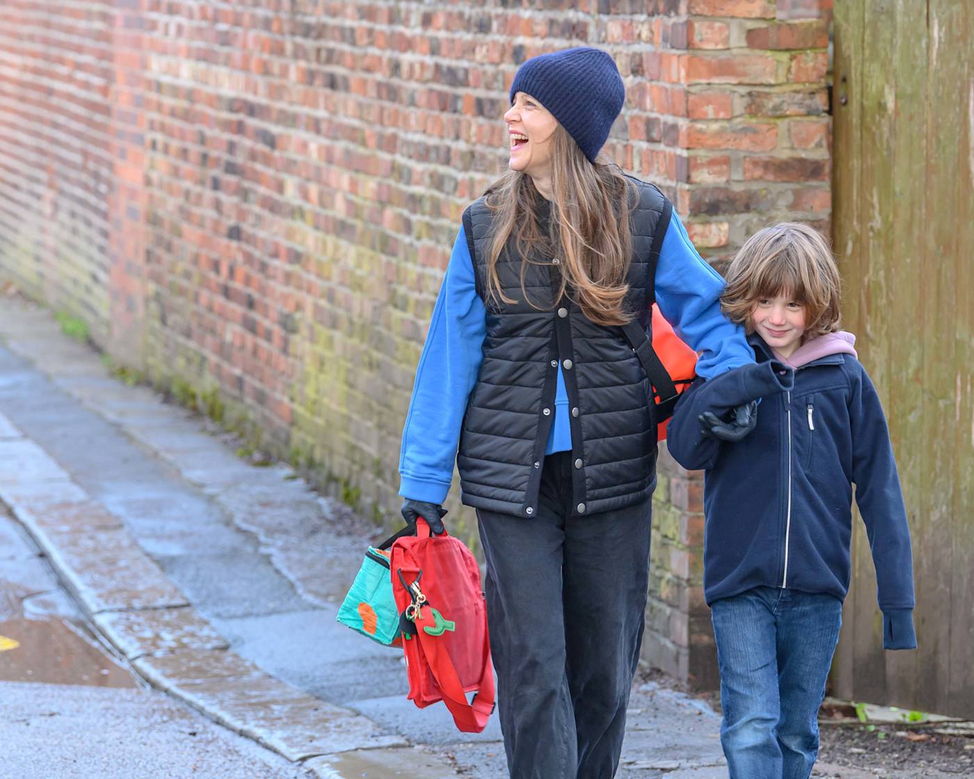 Mother and son walking to school through active neighbourhood square