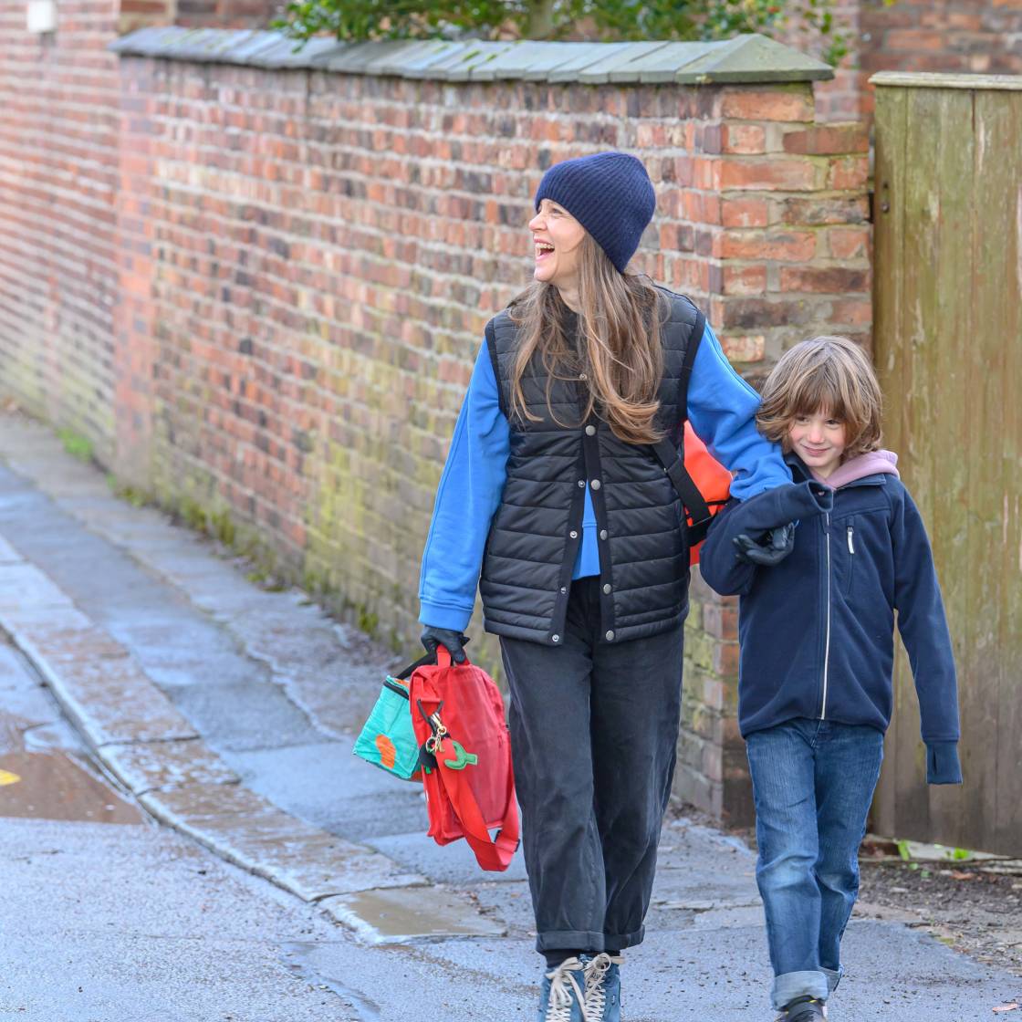 Mother and son walking to school through active neighbourhood square